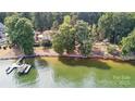Stunning waterfront home with private dock and lush landscaping on a tree-lined lot at 9184 Greenwood Rd, Terrell, NC 28682