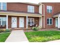 A charming brick townhome with covered front porch, neat landscaping, and inviting curb appeal at 102 Brandywine Ne Dr # O-3, Conover, NC 28613