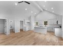 Open-concept living space with vaulted ceilings, hardwood floors, and white trim at 105 Churchill Dr, Kings Mountain, NC 28086