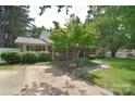 Charming home featuring a cozy front porch, mature tree, and a well-maintained driveway at 109 Larch Rd, Salisbury, NC 28147