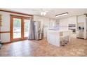 Bright kitchen with stainless steel appliances, center island, and access to the backyard at 109 Larch Rd, Salisbury, NC 28147
