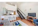 Stylish living space featuring a modern staircase, breakfast bar, and a cozy seating area with a TV at 115 E Park Ave # 409, Charlotte, NC 28203