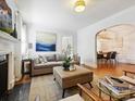 Bright living room with fireplace, neutral furniture, and view into the dining room at 1219 Pinecrest Ave, Charlotte, NC 28205