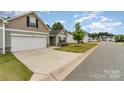 Inviting single-story home with a well-manicured lawn and ample driveway space, creating a welcoming curb appeal at 1405 Amberlight Cir, Salisbury, NC 28144
