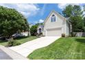 Traditional home featuring an attached two-car garage and a well-manicured lawn at 14218 Springsure Ct, Huntersville, NC 28078