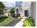 Inviting home entrance with neat landscaping and charming front door at 14218 Springsure Ct, Huntersville, NC 28078