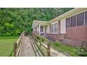 Close up of wood ramp to the front door, brick foundation and concrete walkway at 1435 W Ridge Rd, Salisbury, NC 28147