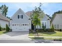 Inviting single-Gathering home featuring a well-manicured lawn and an attached two-car garage at 14531 Crosswater Ln, Charlotte, NC 28278