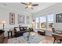 Bright living room with large windows, hardwood floors, and elegant furniture at 14531 Crosswater Ln, Charlotte, NC 28278