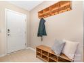 Inviting entryway with coat rack and bench, creating a warm and organized welcome at 1533 Moss Creek Dr, Harrisburg, NC 28075