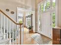 Bright foyer featuring hardwood floors, large windows, and an open entryway to other living spaces at 15929 Northstone Dr, Huntersville, NC 28078