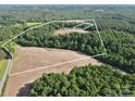 Expansive land with wooded areas and open fields, as seen from an aerial view at 169 Wilcox Karriker Ln, Statesville, NC 28625