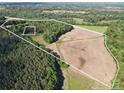 Aerial view showcasing the expansive property with a mix of wooded areas and open fields at 169 Wilcox Karriker Ln, Statesville, NC 28625