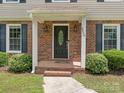 Close-up of the front door with brick accents and detailed trim at 2240 Lawton Bluff Rd, Charlotte, NC 28226