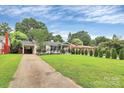 Inviting single-story home showcasing a long driveway and well-maintained front yard at 2421 Shamrock Dr, Charlotte, NC 28205