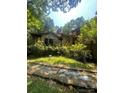 Angle view of brick home with stone accents and lots of surrounding foliage at 2505 White Thorne Ln, Waxhaw, NC 28173