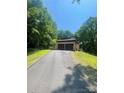 View of home on a wooded lot with an attached two-car garage and a paved driveway at 2505 White Thorne Ln, Waxhaw, NC 28173