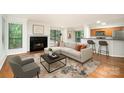 Inviting living room featuring a fireplace, plush seating, and a convenient breakfast bar with stools at 2512 Cranbrook Ln # 9, Charlotte, NC 28207