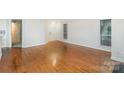 Spacious open-concept living area with gleaming hardwood floors, neutral walls, and plenty of natural light at 2512 Cranbrook Ln # 9, Charlotte, NC 28207