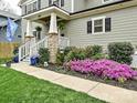 Inviting home exterior featuring mature landscaping, pink azaleas, green shrubs, and a stone-lined walkway at 2518 Pinckney Ave, Charlotte, NC 28205