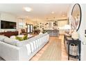 Open-concept living room featuring hardwood floors, neutral decor, modern furnishings, and lots of natural light at 2518 Pinckney Ave, Charlotte, NC 28205