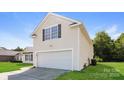Charming home featuring a two-car garage, lawn, and neutral siding at 2599 April Showers Ln, Rock Hill, SC 29730