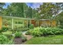 Exterior view showcasing an inviting front entrance with modern design and natural landscaping at 2600 Cloister Dr, Charlotte, NC 28211