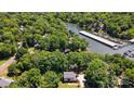Expansive aerial shot showcasing a lakeside home nestled in lush greenery near the community marina at 29049 Snapper Pt, Tega Cay, SC 29708