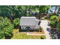 Aerial view of a charming two-story home with landscaped yard and lakeside driveway at 29049 Snapper Pt, Tega Cay, SC 29708