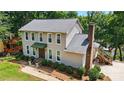 Charming two-story home featuring a brick chimney, well-manicured bushes, and lush green lawn at 29049 Snapper Pt, Tega Cay, SC 29708