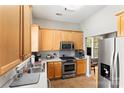 Cozy kitchen with stainless steel appliances, wood cabinets, and warm tile flooring at 3007 Colonel Springs Way, Fort Mill, SC 29708