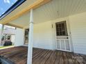 Inviting front porch featuring a vintage screen door, classic columns and natural wood accents at 324 S Spruce St, Rock Hill, SC 29730