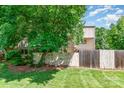 Grassy backyard featuring a privacy fence, mature shade tree, and neutral siding of home at 3617 Willow Point Dr, Charlotte, NC 28277