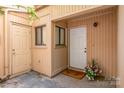 Cozy entryway with beige siding, a white front door, and a charming flower arrangement for a welcoming feel at 3617 Willow Point Dr, Charlotte, NC 28277