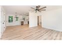 Open-concept living space with modern flooring, ceiling fan, and access to kitchen, creating seamless flow at 406 N Bostian St, China Grove, NC 28023