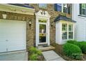Close-up of the front door with decorative trim and sidelight window on a brick facade at 513 Pate Dr, Fort Mill, SC 29715