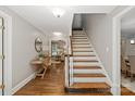 Inviting foyer with hardwood floors, a staircase, and views of the living areas at 516 Amanda Dr, Weddington, NC 28104