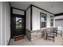 Cozy front porch with stone accents, seating, and a welcoming entrance to the home at 602 Compass Dr, Denver, NC 28037