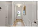 Bright hallway featuring hardwood floors, neutral walls, and ample natural light at 602 Compass Dr, Denver, NC 28037