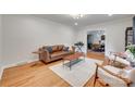 Bright living room featuring hardwood floors, neutral paint, and comfortable seating at 6626 Rocky Falls Rd, Charlotte, NC 28211