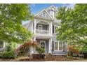 Charming two-story home with a covered front porch and manicured landscaping at 7043 Blakeney Greens Blvd, Charlotte, NC 28277