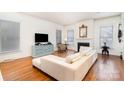 Bright living room with a fireplace, hardwood floors, and ample natural light at 7043 Blakeney Greens Blvd, Charlotte, NC 28277