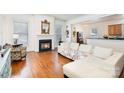 Inviting living room with a fireplace and hardwood floors at 7043 Blakeney Greens Blvd, Charlotte, NC 28277