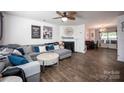 Spacious living room with a fireplace, ceiling fan, and stylish decor at 7527 Finnigan Rd, Charlotte, NC 28215