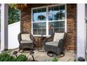 Cozy front porch with comfortable wicker seating, perfect for relaxing outdoors at 7527 Finnigan Rd, Charlotte, NC 28215