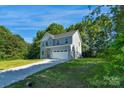 Beautiful two-story home with a light blue exterior, attached two-car garage, and expansive front lawn at 7874 Lucky Creek Ln, Denver, NC 28037