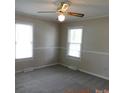 Bedroom with plush carpet, fresh neutral paint, a ceiling fan, and bright, sunny windows at 809 Ruth Ave, Kannapolis, NC 28083