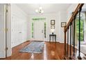 Bright foyer featuring hardwood floors, white walls, and a front door with sidelights at 8217 Lansford Rd, Charlotte, NC 28277