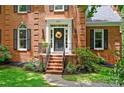 Close-up of the front door with a wreath and brick steps leading to the entrance at 8217 Lansford Rd, Charlotte, NC 28277
