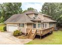 Back of the home features a spacious wooden deck perfect for outdoor entertaining and relaxing at 8622 Lower Rocky River Rd, Concord, NC 28025